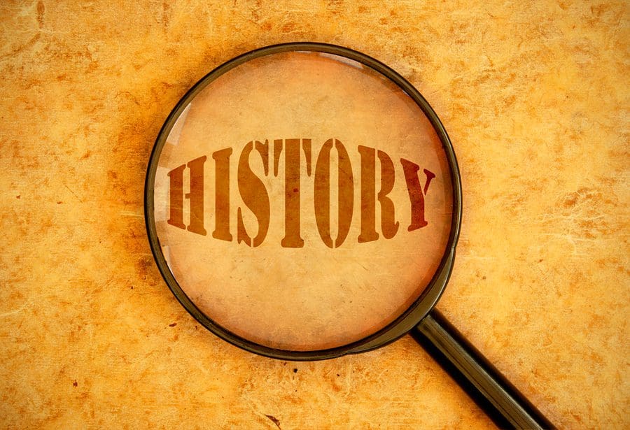 A magnifying glass with the word " history " in it.