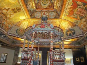 A room with many paintings on the ceiling