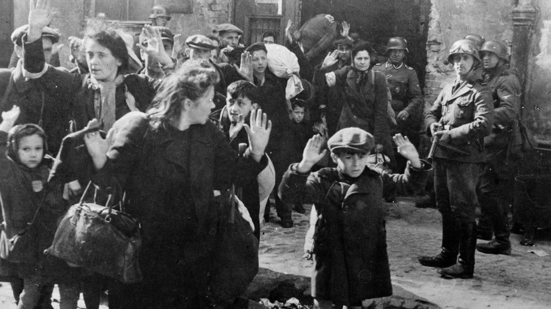 A group of people standing around in the street.