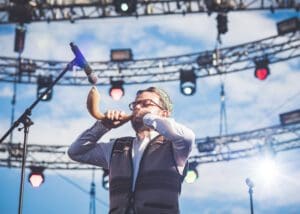 A man holding an oboe in his hand.