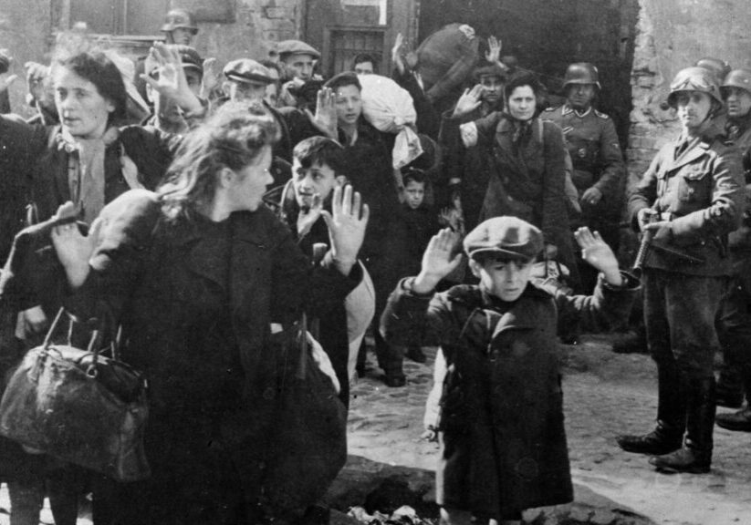 A group of people standing around in the street.