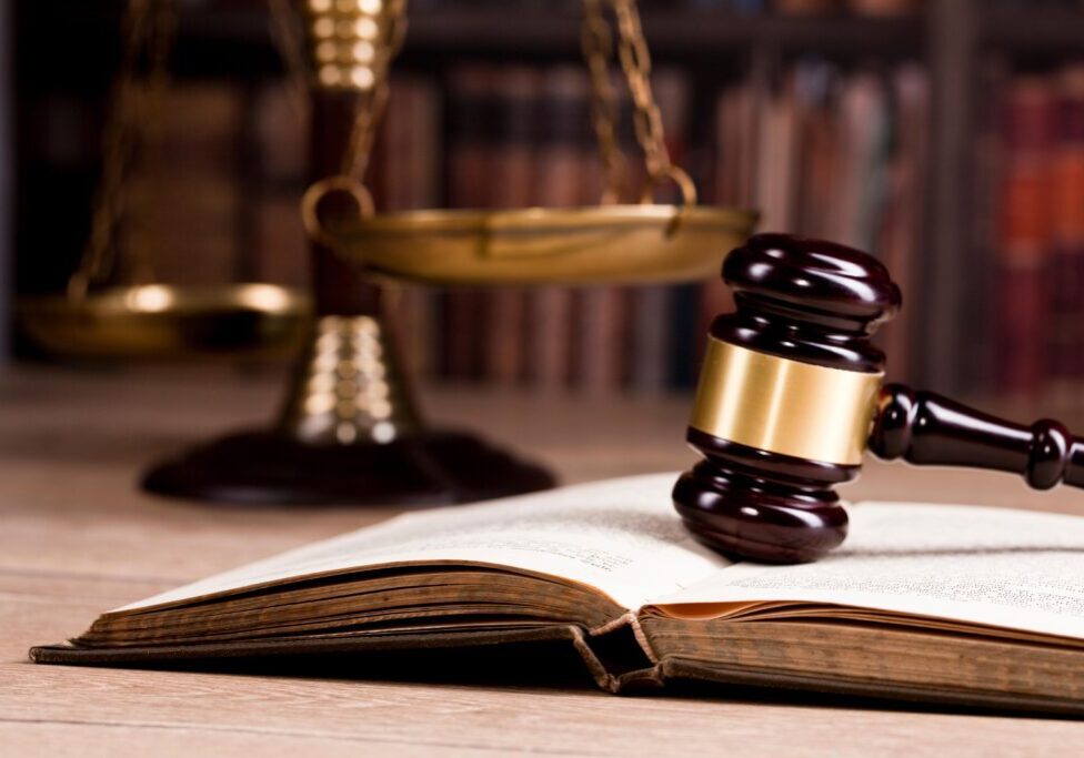 A judge 's gavel sitting on top of an open book.